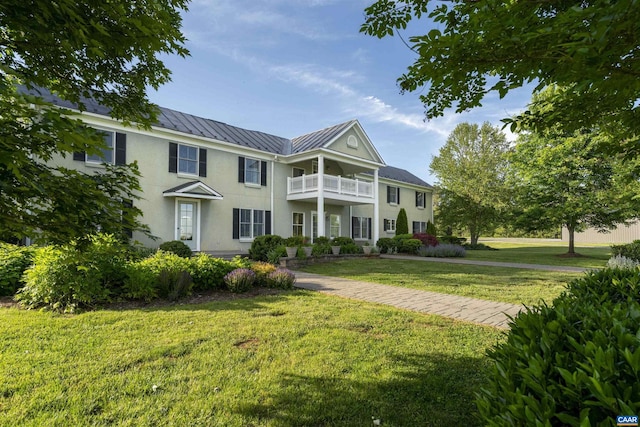 928 Slate Mill Rd Unit B, Stanardsville, VA 22973 - neoclassical home featuring a standing seam roof, stucco siding, a balcony, a front lawn, and a metal roof
