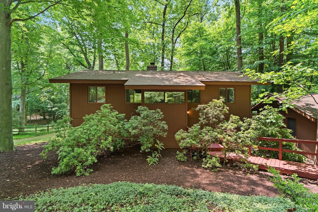 5515 Hillfall Ct, Columbia, MD 21045 - view of front of house with a shingled roof, a chimney, and a wooden deck