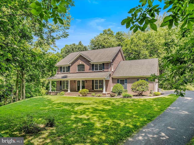 150 Morgana Dr, Shepherdstown, WV 25443 - colonial house with brick siding, a front lawn, a porch, and a shingled roof