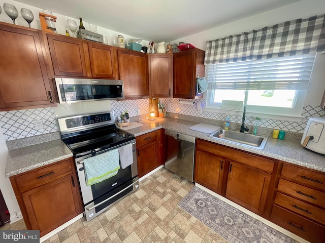 8 Aidone Ln, Smyrna, DE 19977 - kitchen with appliances with stainless steel finishes, tasteful backsplash, light countertops, and brown cabinets