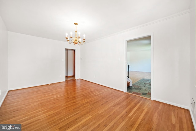 2621 Dartmouth Woods Rd, Wilmington, DE 19810 - unfurnished room featuring a chandelier, light wood-style flooring, and ornamental molding