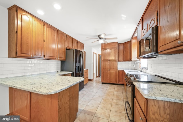 2621 Dartmouth Woods Rd, Wilmington, DE 19810 - kitchen with electric range oven, stainless steel microwave, a peninsula, fridge with ice dispenser, and brown cabinetry