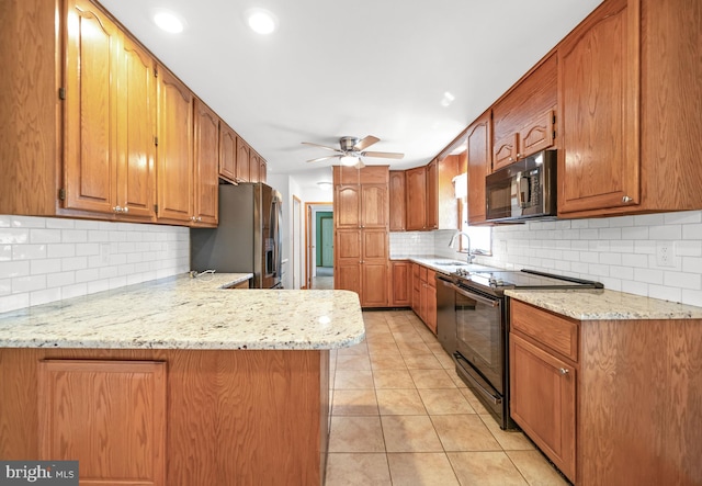 2621 Dartmouth Woods Rd, Wilmington, DE 19810 - kitchen featuring black appliances, a ceiling fan, tasteful backsplash, a peninsula, and light tile patterned floors