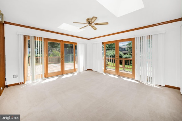 2621 Dartmouth Woods Rd, Wilmington, DE 19810 - carpeted empty room with a skylight, french doors, ceiling fan, and ornamental molding