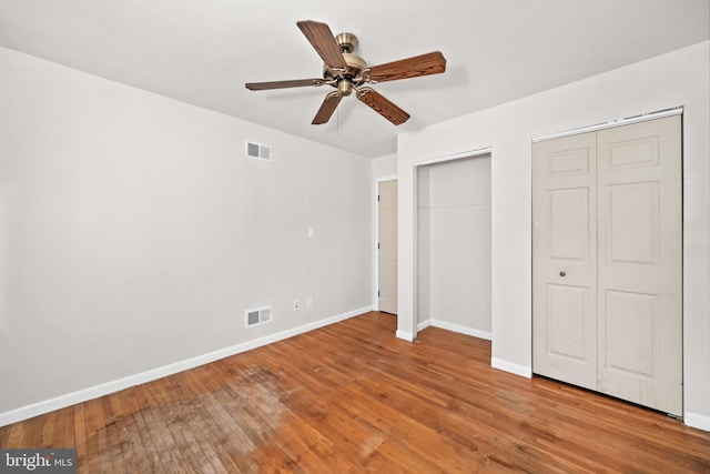 2621 Dartmouth Woods Rd, Wilmington, DE 19810 - unfurnished bedroom featuring multiple closets, hardwood / wood-style flooring, and ceiling fan