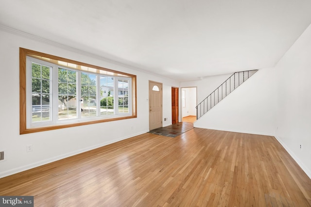 2621 Dartmouth Woods Rd, Wilmington, DE 19810 - unfurnished living room with wood finished floors, stairway, and crown molding
