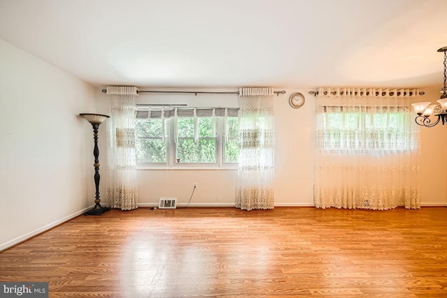 231 Candytuft Rd, Reisterstown, MD 21136 - empty room featuring a chandelier and wood finished floors