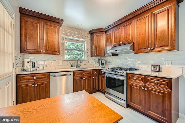 231 Candytuft Rd, Reisterstown, MD 21136 - kitchen featuring stainless steel appliances, under cabinet range hood, backsplash, light countertops, and light wood-style flooring