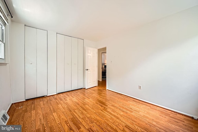 231 Candytuft Rd, Reisterstown, MD 21136 - unfurnished bedroom featuring wood finished floors and two closets