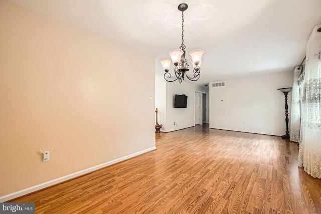231 Candytuft Rd, Reisterstown, MD 21136 - unfurnished room featuring a chandelier and wood finished floors