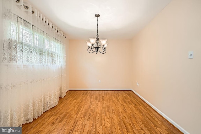 231 Candytuft Rd, Reisterstown, MD 21136 - spare room with wood finished floors and a chandelier