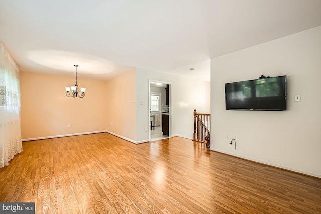 231 Candytuft Rd, Reisterstown, MD 21136 - unfurnished living room featuring a chandelier and light wood finished floors