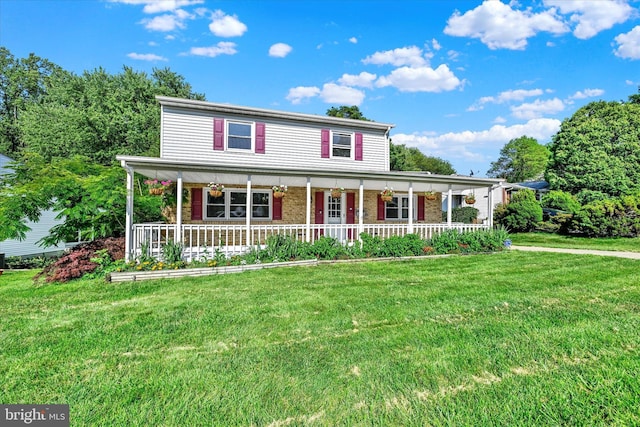127 W Chestnut Hill Ln, Reisterstown, MD 21136 - view of front facade with a porch, a front yard, and brick siding