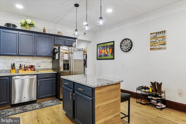 432 Mcdowell Ave, Hagerstown, MD 21740 - kitchen featuring stainless steel appliances, decorative backsplash, a kitchen breakfast bar, light wood-style floors, and pendant lighting