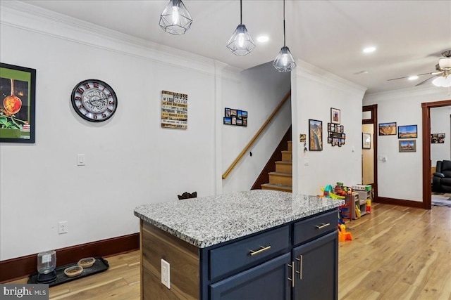 432 Mcdowell Ave, Hagerstown, MD 21740 - kitchen with crown molding, a ceiling fan, light wood-type flooring, blue cabinetry, and decorative light fixtures