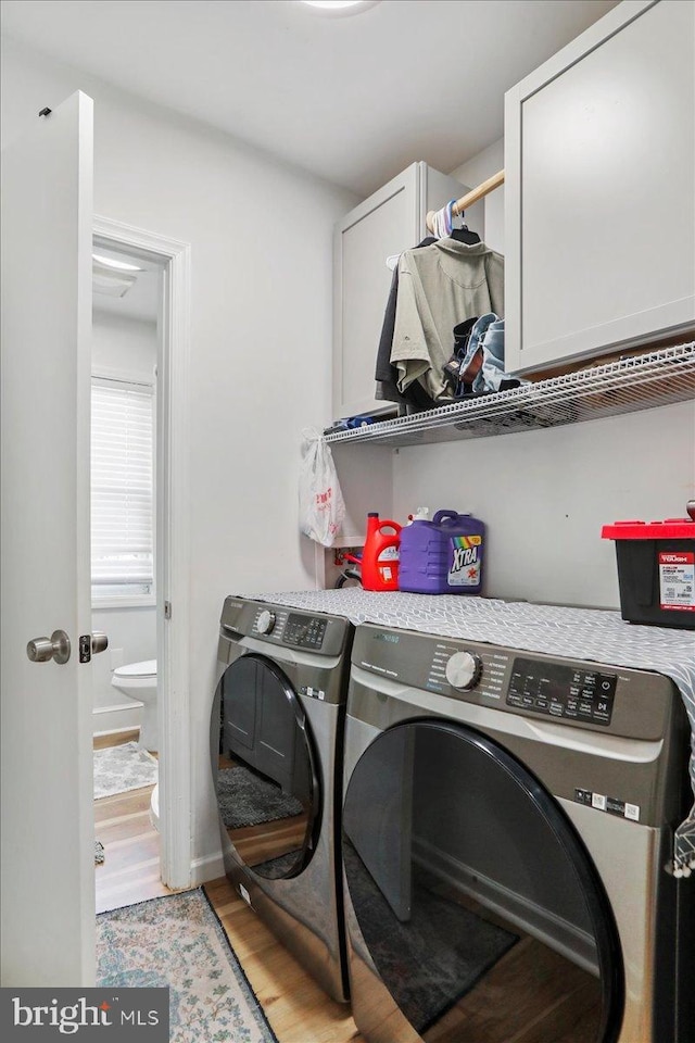 432 Mcdowell Ave, Hagerstown, MD 21740 - laundry room featuring cabinet space, washer and dryer, and light wood-type flooring