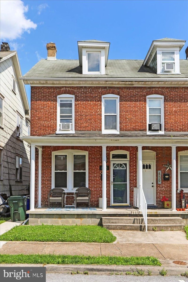 432 Mcdowell Ave, Hagerstown, MD 21740 - view of property with a porch, brick siding, cooling unit, and a chimney