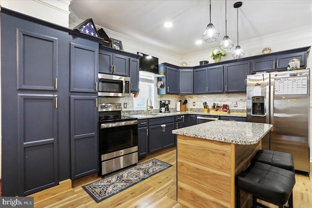 432 Mcdowell Ave, Hagerstown, MD 21740 - kitchen with stainless steel appliances, ornamental molding, light wood finished floors, a kitchen bar, and backsplash