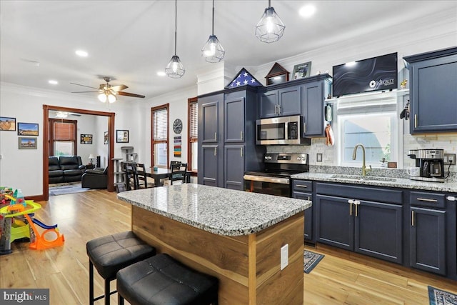 432 Mcdowell Ave, Hagerstown, MD 21740 - kitchen featuring appliances with stainless steel finishes, crown molding, tasteful backsplash, a ceiling fan, and light stone counters