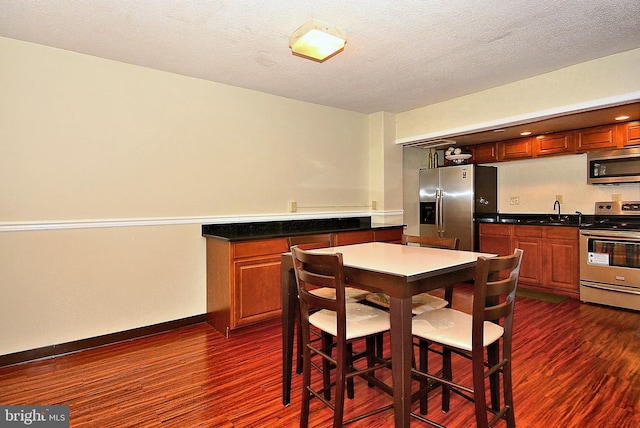 2059 Huntington Ave Unit 1406, Alexandria, VA 22303 - dining space with dark wood-style floors and bar with sink