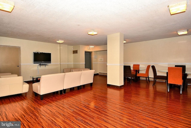 2059 Huntington Ave Unit 1406, Alexandria, VA 22303 - living area featuring wood finished floors, a textured ceiling, and a baseboard heating unit