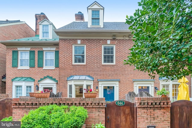 644 S Columbus St, Alexandria, VA 22314 - view of front of property with a gate, brick siding, roof with shingles, and a chimney