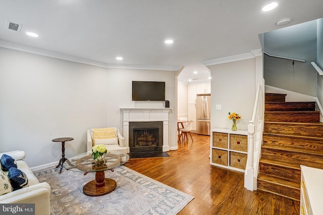 644 S Columbus St, Alexandria, VA 22314 - living area with stairs, crown molding, wood finished floors, a fireplace with flush hearth, and recessed lighting