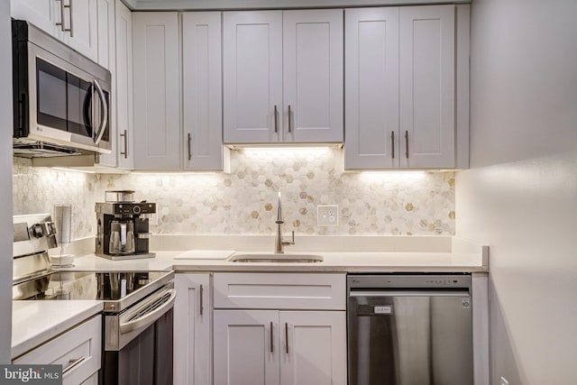 644 S Columbus St, Alexandria, VA 22314 - kitchen with stainless steel appliances, light countertops, backsplash, and white cabinetry