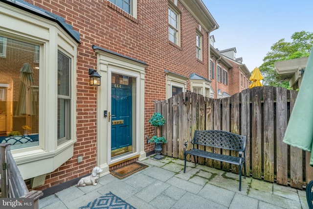 644 S Columbus St, Alexandria, VA 22314 - view of exterior entry featuring brick siding and a patio