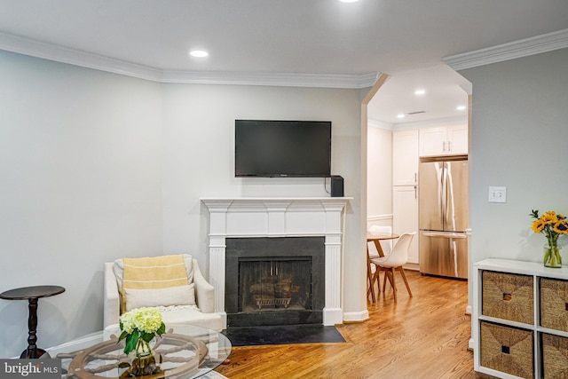 644 S Columbus St, Alexandria, VA 22314 - living room featuring light wood-type flooring, recessed lighting, ornamental molding, and a fireplace with flush hearth