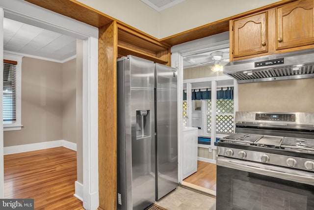 32 W Willow St, Carlisle, PA 17013 - kitchen featuring stainless steel appliances, exhaust hood, ornamental molding, and light wood-style flooring