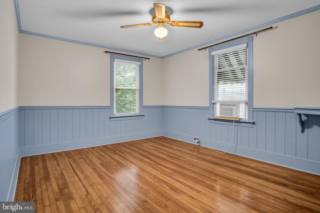 32 W Willow St, Carlisle, PA 17013 - empty room with a wainscoted wall, cooling unit, wood finished floors, ornamental molding, and ceiling fan