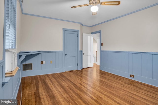32 W Willow St, Carlisle, PA 17013 - spare room featuring wood-type flooring, wainscoting, a ceiling fan, and ornamental molding