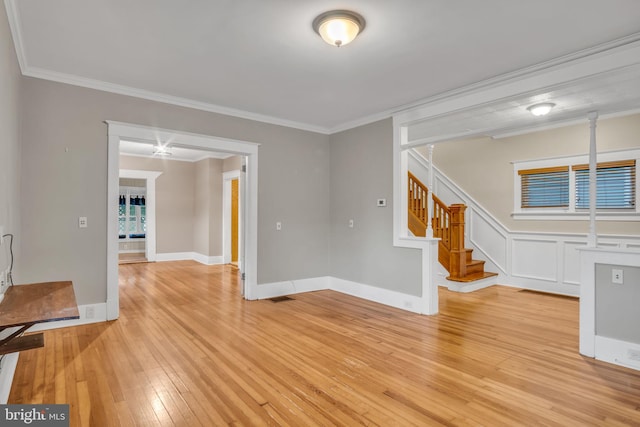 32 W Willow St, Carlisle, PA 17013 - empty room with light wood-style floors, ornamental molding, and stairway