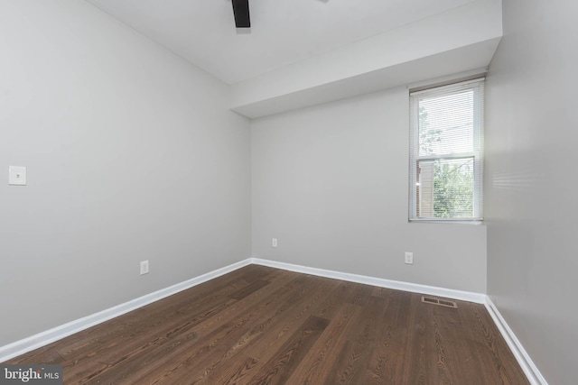 1715 E Oliver St, Baltimore, MD 21213 - empty room with dark wood-style floors and a ceiling fan