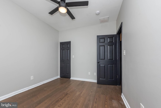 1715 E Oliver St, Baltimore, MD 21213 - unfurnished bedroom featuring dark wood-style floors and a ceiling fan