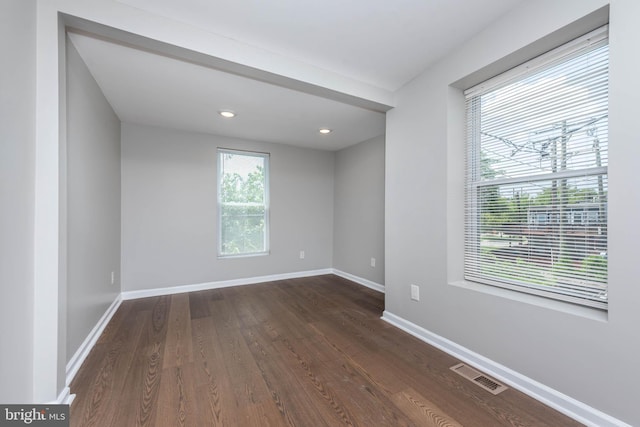 1715 E Oliver St, Baltimore, MD 21213 - empty room featuring dark wood-style flooring and recessed lighting