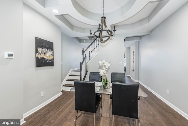 1715 E Oliver St, Baltimore, MD 21213 - dining space featuring dark wood finished floors, a chandelier, stairway, and a raised ceiling