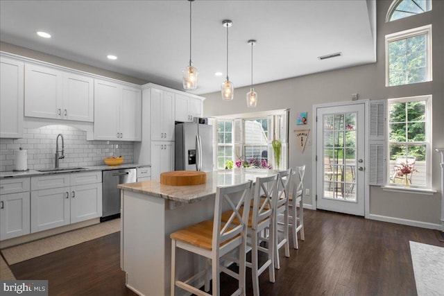 420 Fairview Way, New Hope, PA 18938 - kitchen with appliances with stainless steel finishes, dark wood finished floors, white cabinetry, backsplash, and light stone countertops