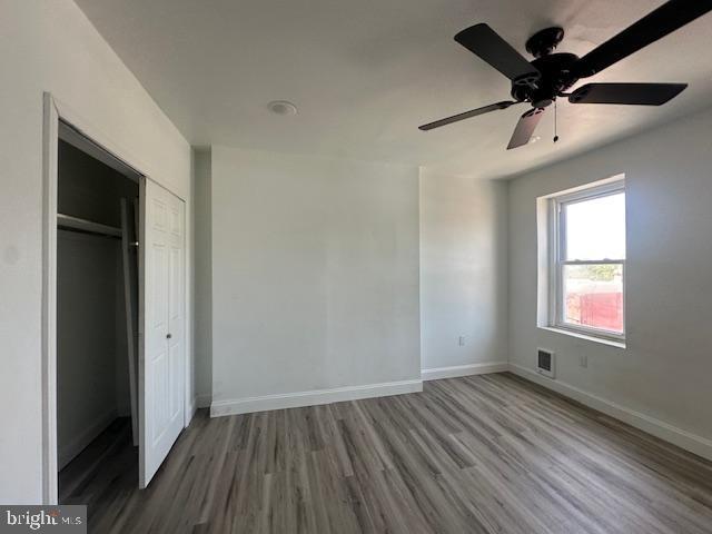 2521 N 12th St, Philadelphia, PA 19133 - unfurnished bedroom with wood finished floors, a closet, and a ceiling fan