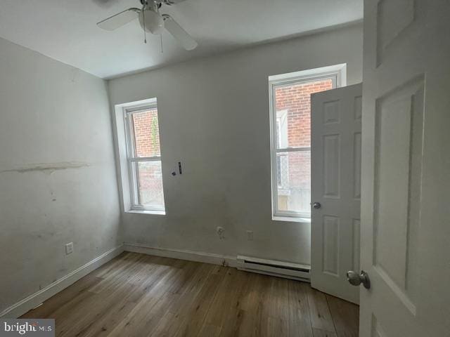 2521 N 12th St, Philadelphia, PA 19133 - unfurnished room featuring a baseboard radiator, wood finished floors, and ceiling fan