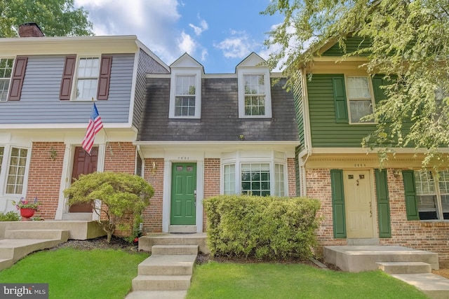 3953 Pepperidge Ct, Woodbridge, VA 22192 - view of property featuring brick siding, roof with shingles, a chimney, and a front lawn