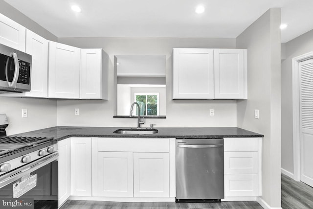 3 Villanova Ct, Sicklerville, NJ 08081 - kitchen with appliances with stainless steel finishes, wood finished floors, white cabinetry, recessed lighting, and dark stone countertops