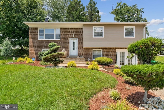 9405 Loughran Rd, Fort Washington, MD 20744 - bi-level home featuring brick siding and a front lawn