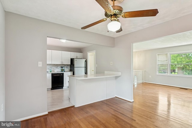 9405 Loughran Rd, Fort Washington, MD 20744 - kitchen featuring freestanding refrigerator, dishwasher, a peninsula, light wood finished floors, and white cabinets