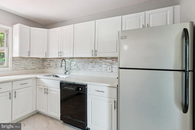 9405 Loughran Rd, Fort Washington, MD 20744 - kitchen with freestanding refrigerator, black dishwasher, white cabinetry, light countertops, and light marble finish floors