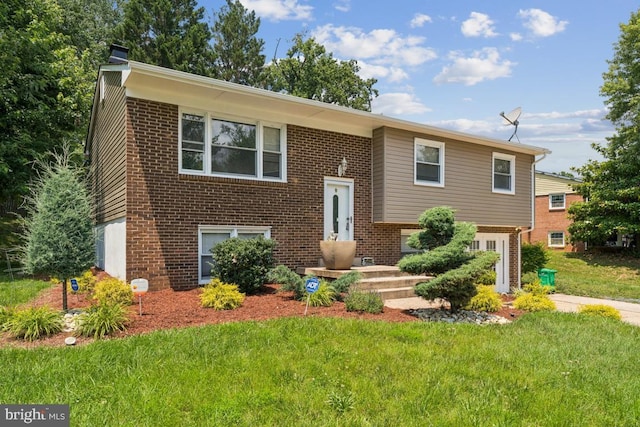 9405 Loughran Rd, Fort Washington, MD 20744 - raised ranch featuring a front yard and brick siding