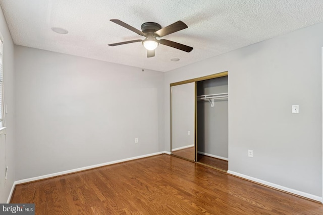 9405 Loughran Rd, Fort Washington, MD 20744 - unfurnished bedroom with wood finished floors, a closet, a textured ceiling, and ceiling fan