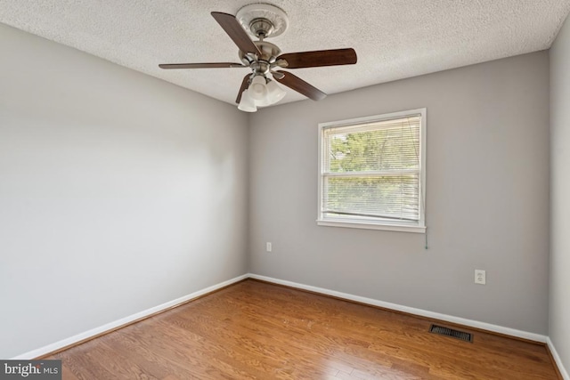 9405 Loughran Rd, Fort Washington, MD 20744 - empty room featuring ceiling fan, wood finished floors, and a textured ceiling
