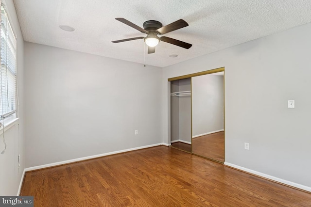 9405 Loughran Rd, Fort Washington, MD 20744 - unfurnished bedroom featuring wood finished floors, a closet, a ceiling fan, and a textured ceiling